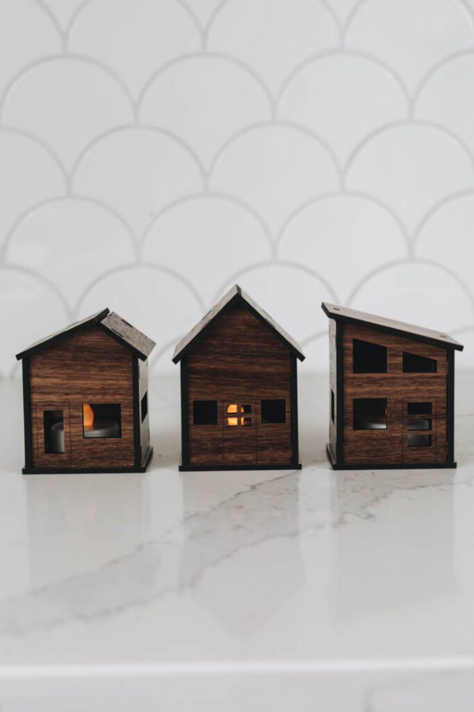 Mini houses made from a Glowforge machine with tealights inside