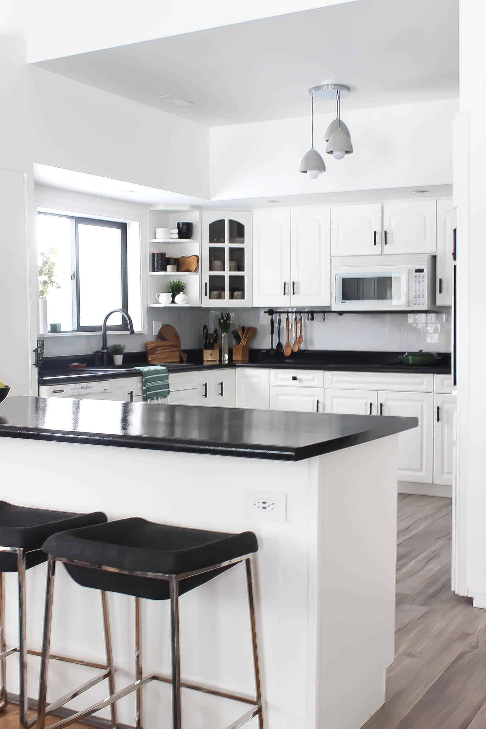 Modern white and black kitchen with glass tile
