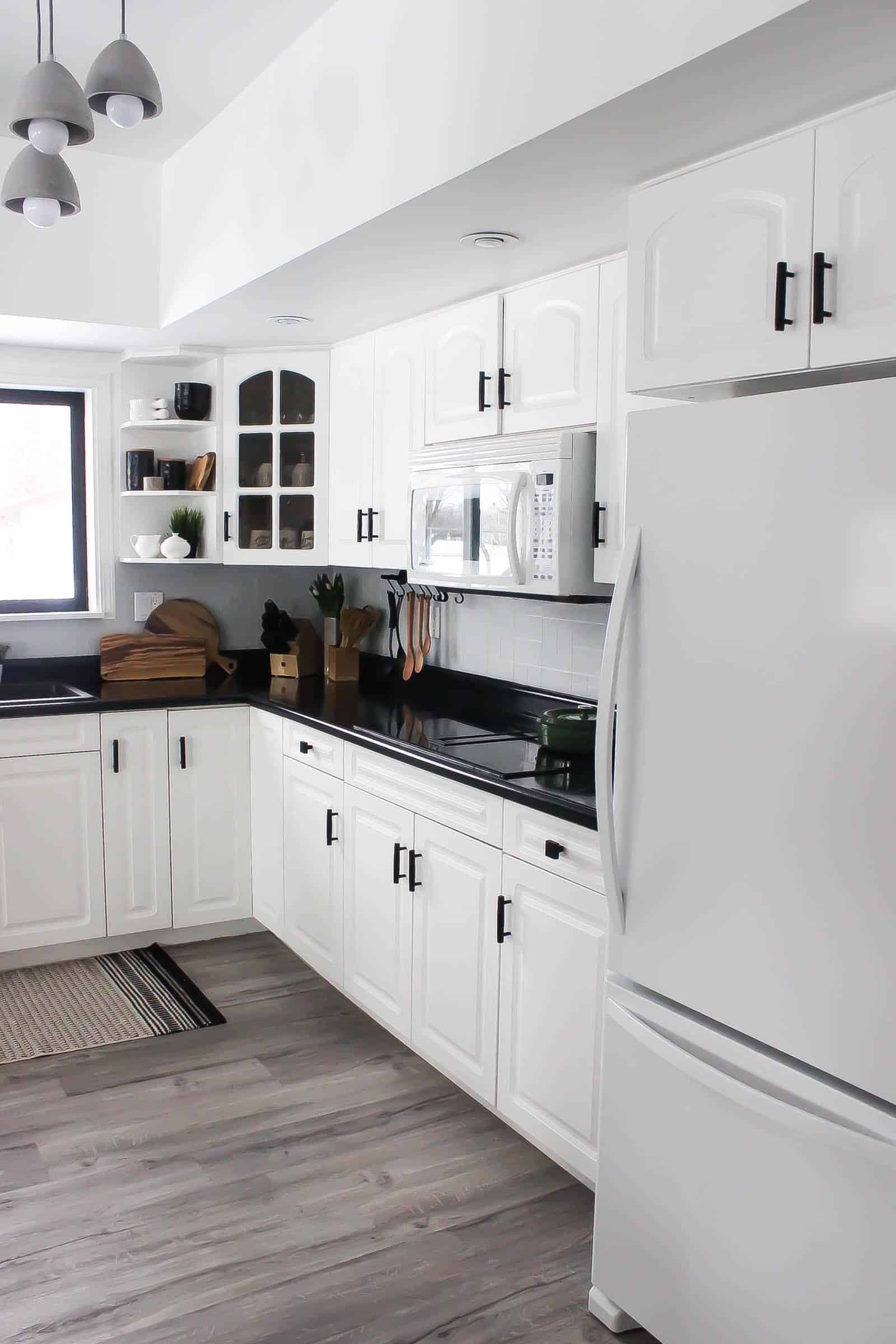Modern white and black kitchen with glass tile